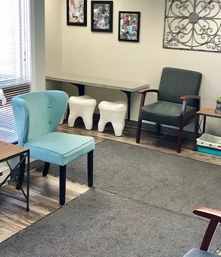 The Granger Dental Group waiting room, with tooth-shaped stools and framed photographs.