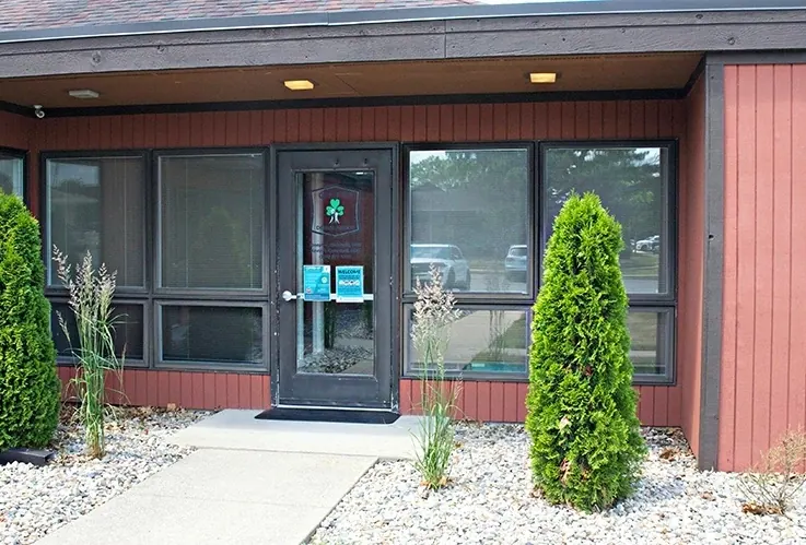 The front entrance of Granger Dental Group, with the shamrock logo on the glass door.